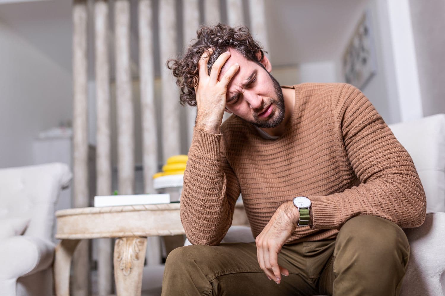 Woman holding her head due to a chronic daily headache